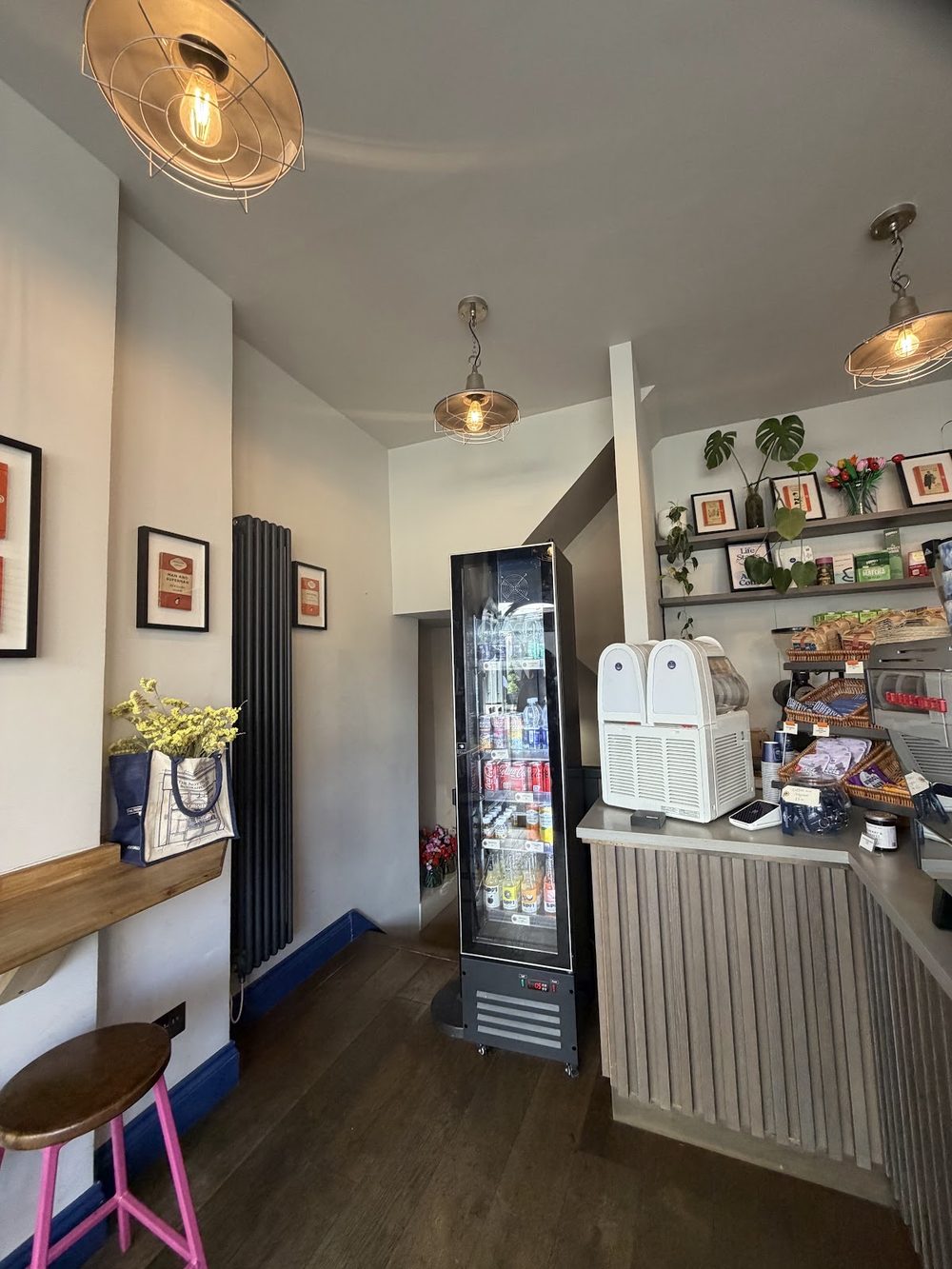 Wider view along the café room towards the service counter and shelving