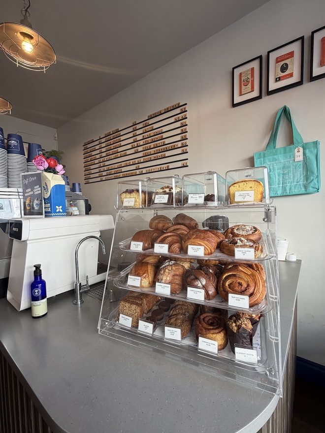 The counter display case of pastries and cinnamon buns