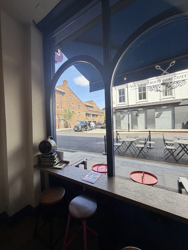 Stools at the window counter looking out through the arched window
