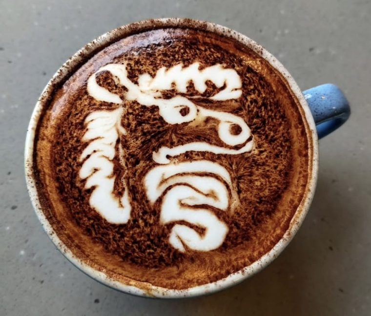 Cappuccino with a seahorse etched in the dusted foam